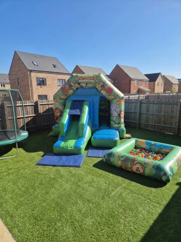 Jungle Adventure castle and slide combo set up on a lawn